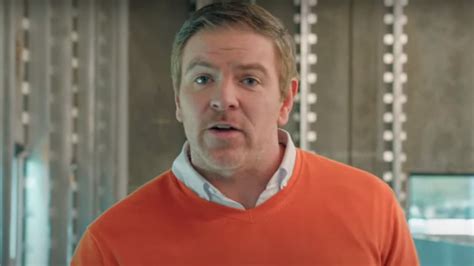 consumer cellular actor orange sweater